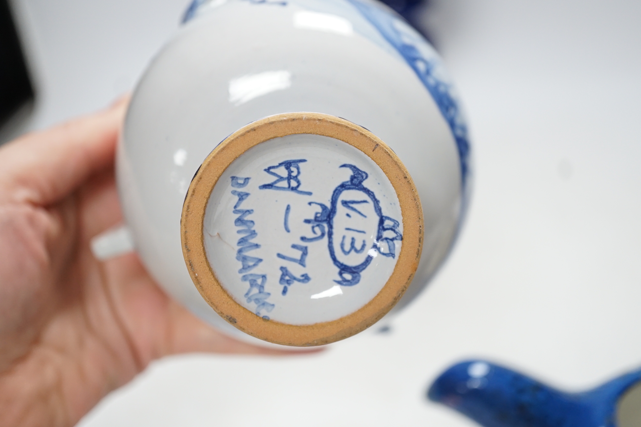 Two Danish ceramic items designed by Bjorn Wiinblad; a lidded pedestal cup in the form of a head with large hat and a candlestick, 26cm high, together with a bird sauce boat signed BJ on base (Berte Jesson)